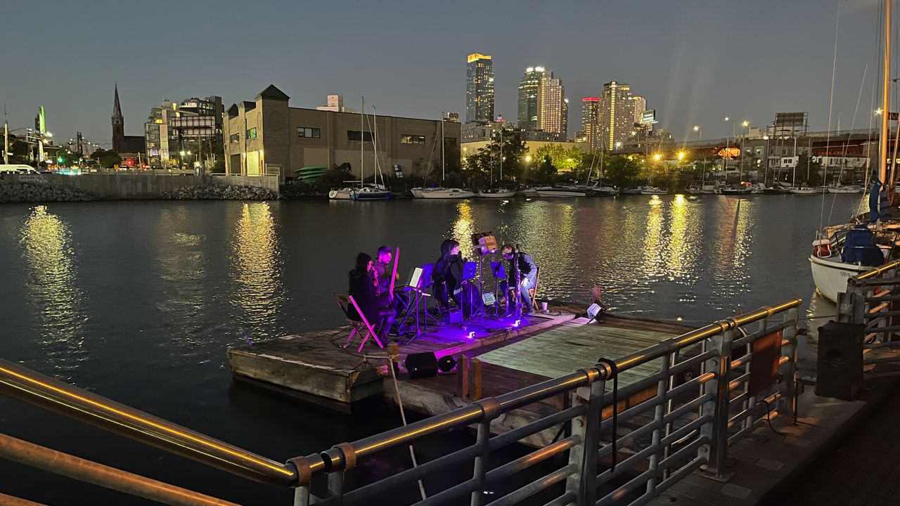 The Unheard-of Ensemble performing on a barge