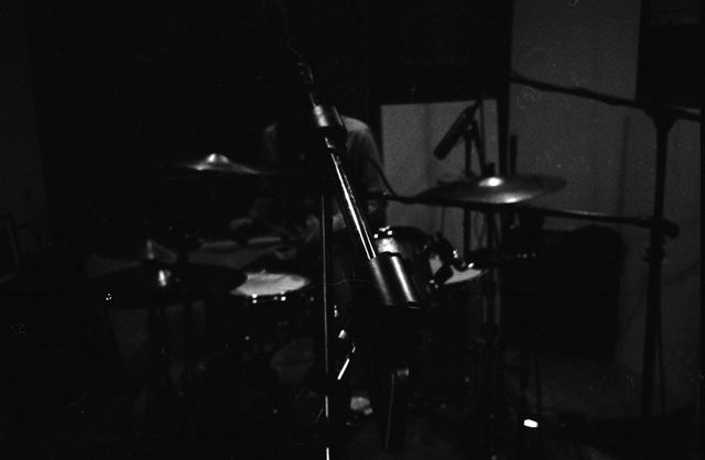 Dim photo of a drumset